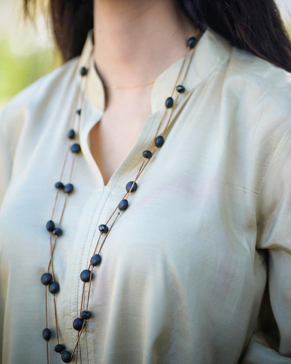 Close up on the neckline of beige dress.
