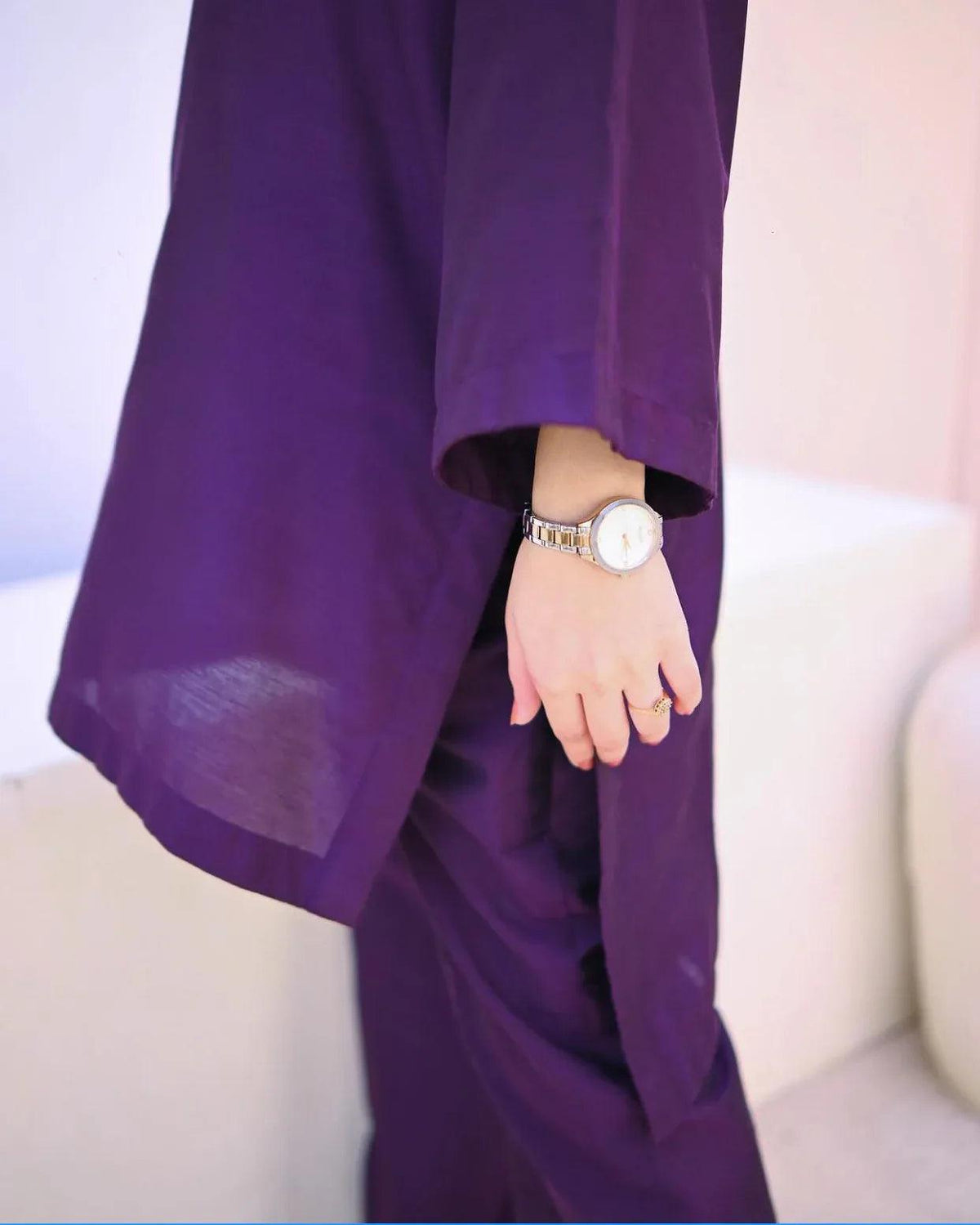 Close up of the women wearing a purple dress.