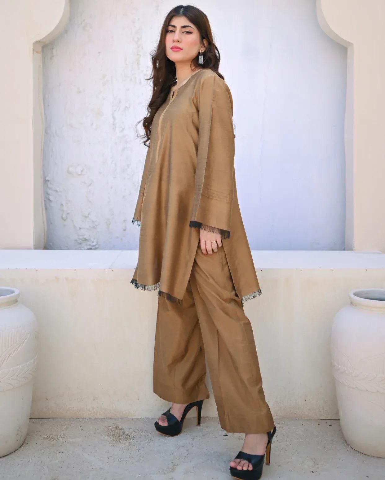 Woman wearing a beige outfit with a light background