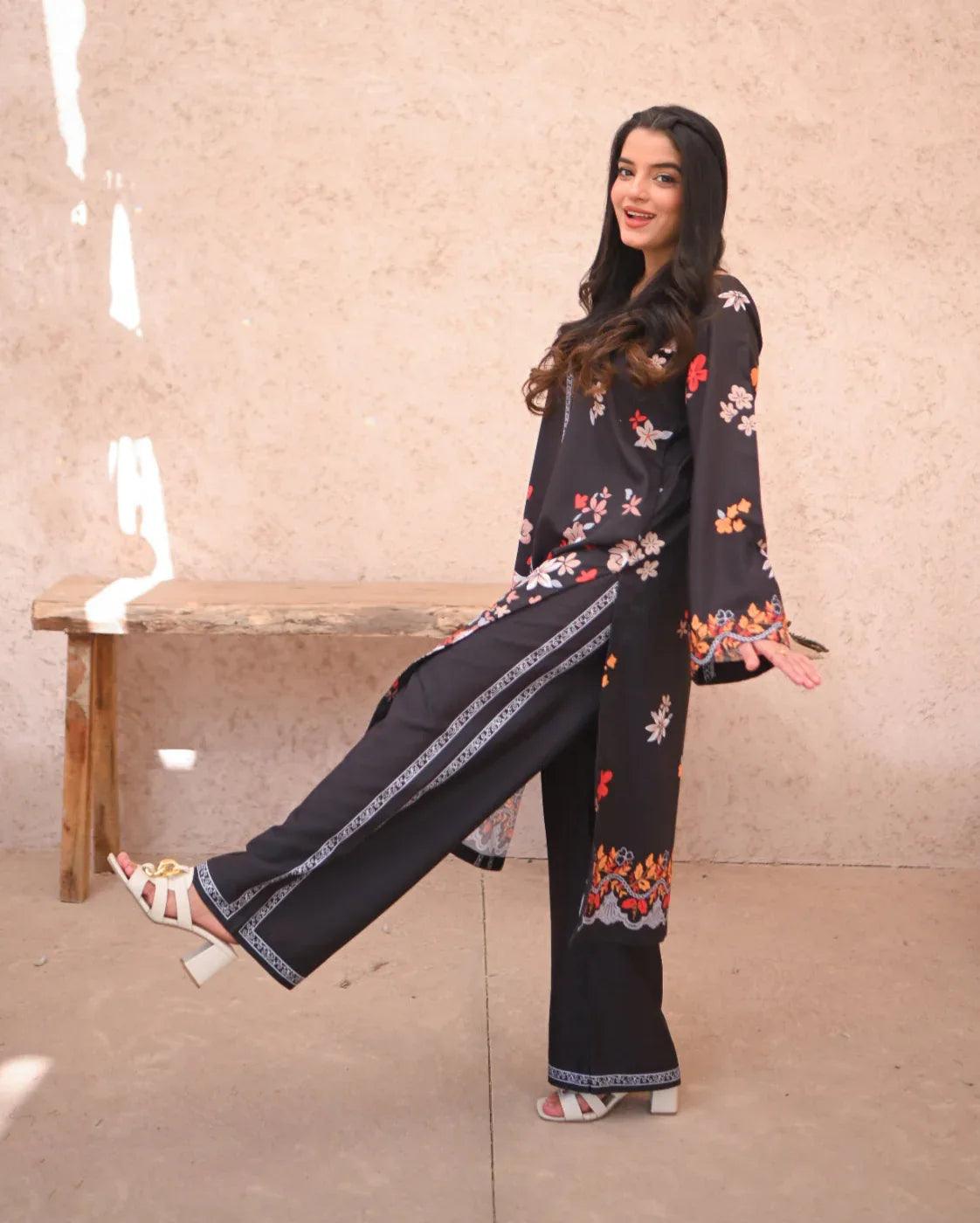 Women wearing a printed black two piece dress.