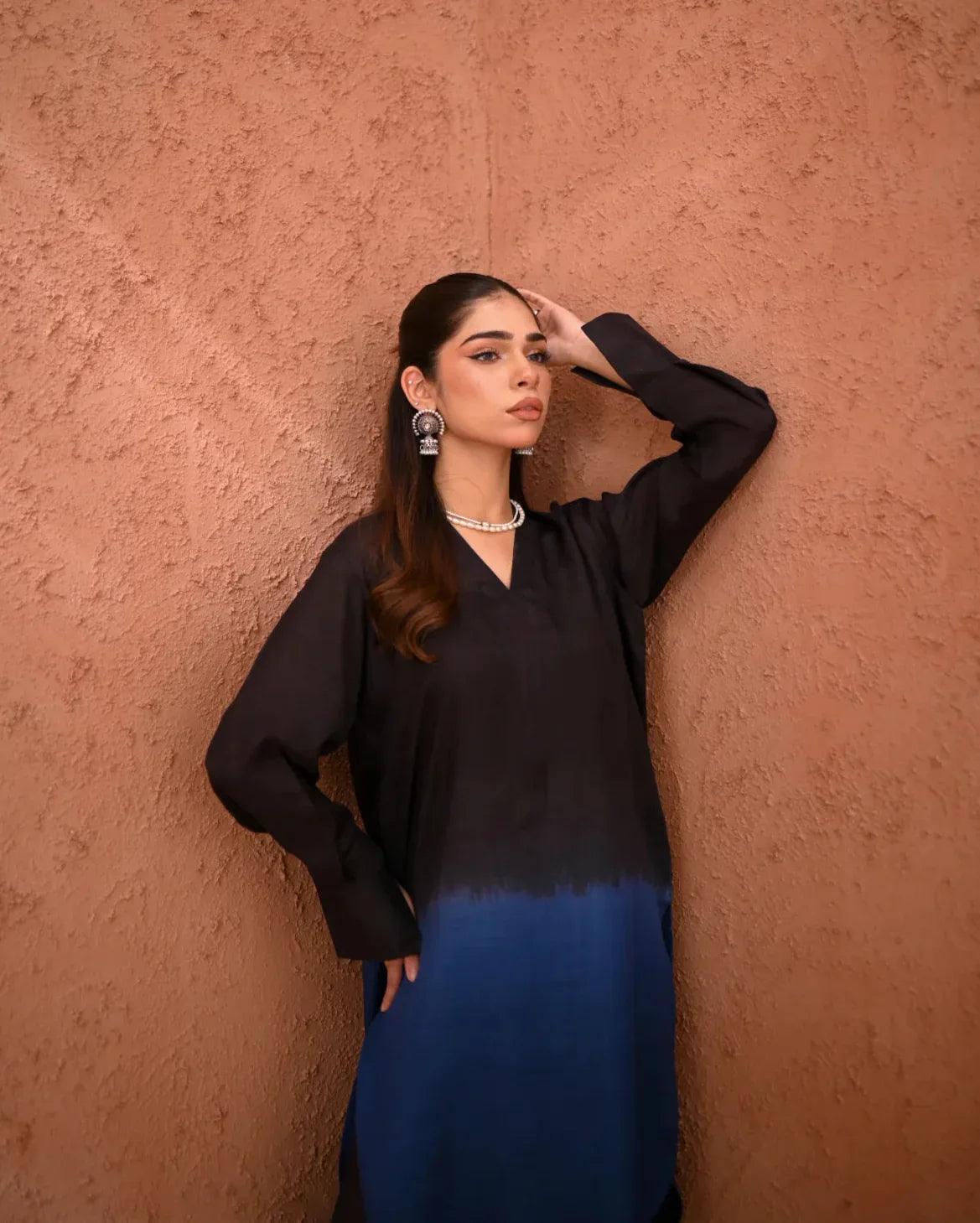 A woman wearing a Rawsilk Ombre shirt standing in a room with earthen tones.