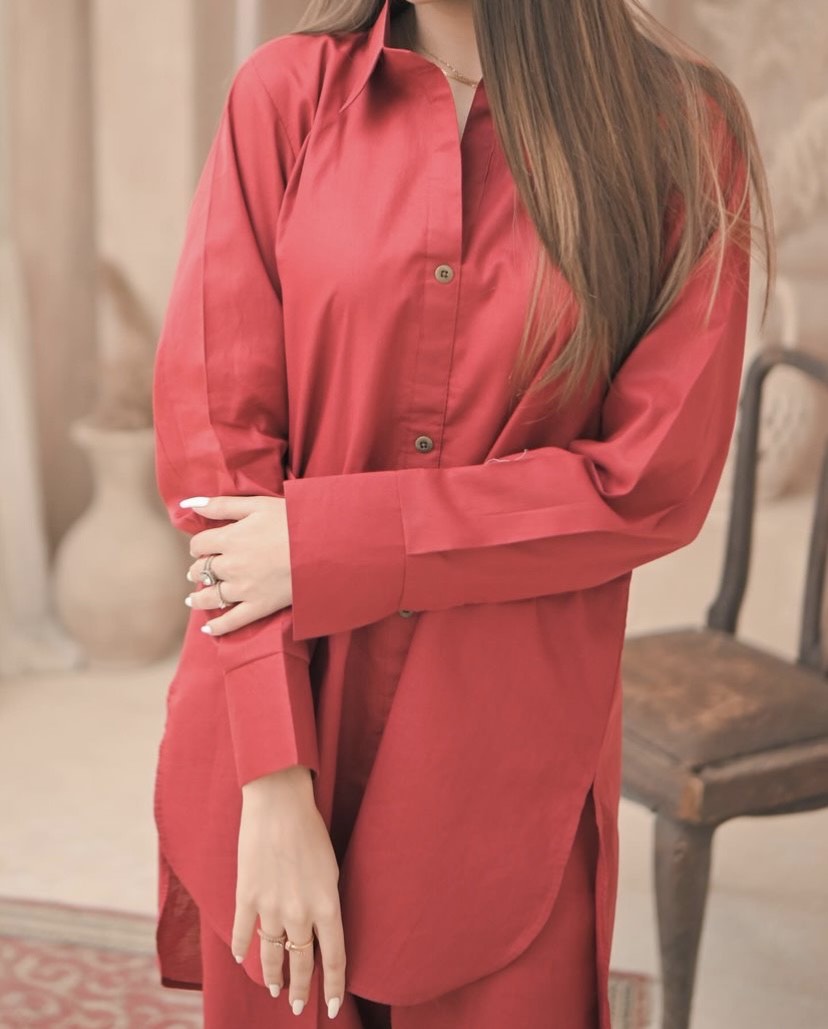 Close up of the women wearing red button down shirt.