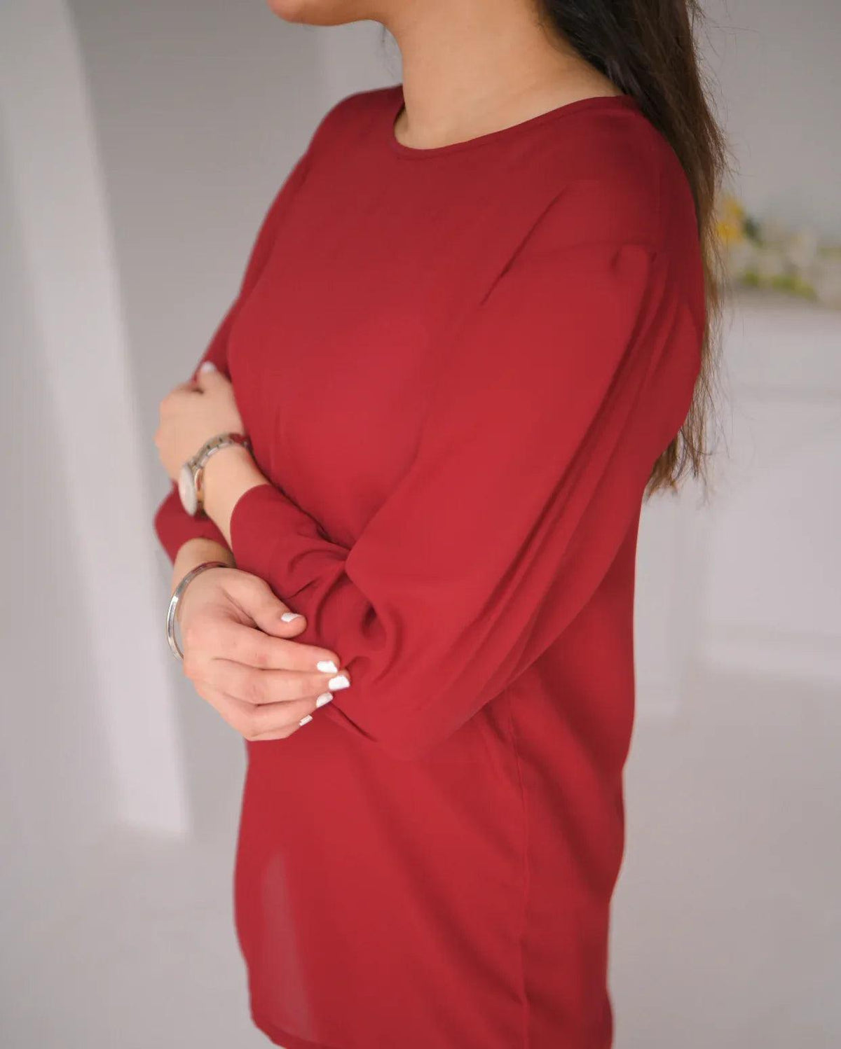 Close up of the women wearing a red top.