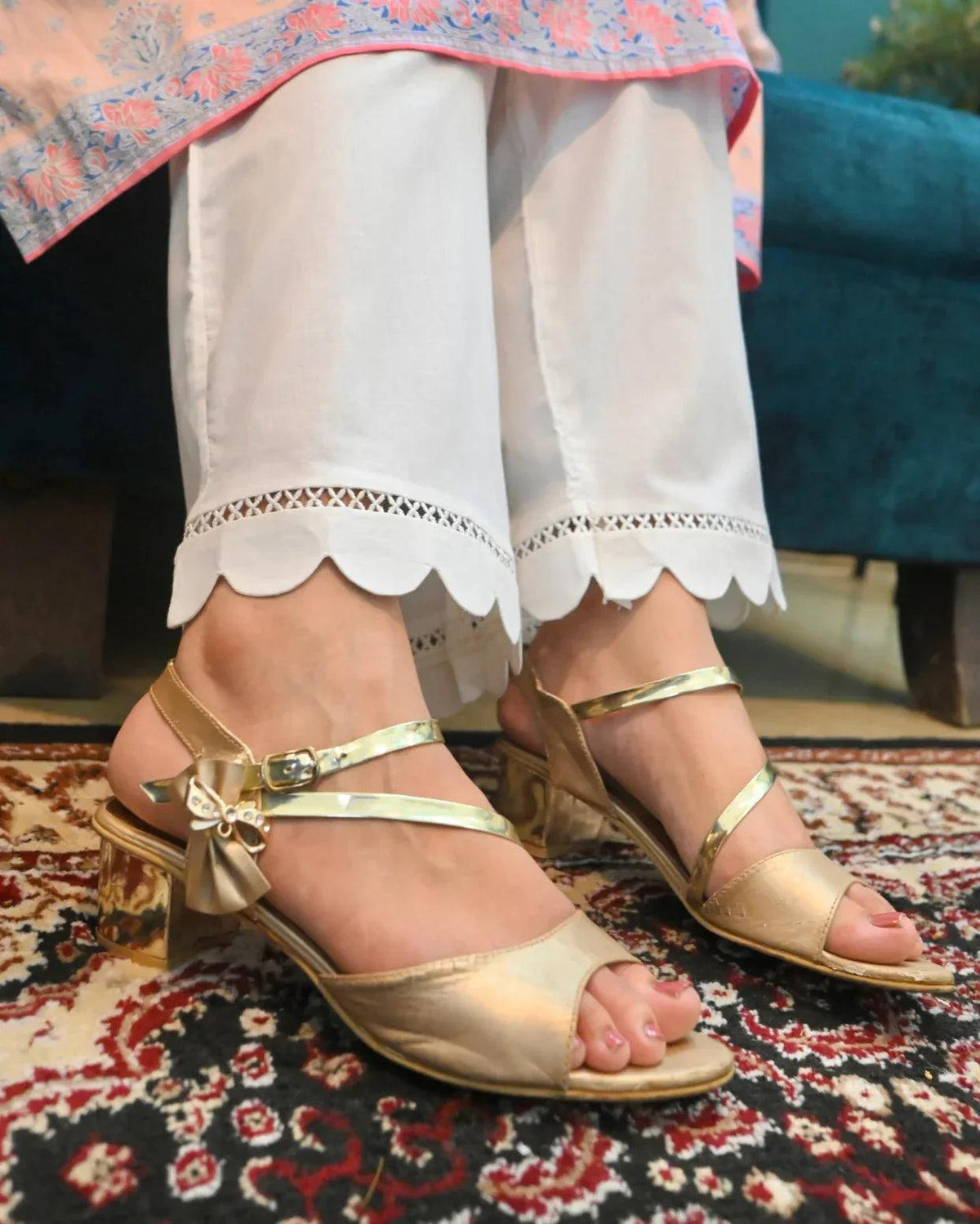 White Culotte with scalloped hem worn by a person on a patterned rug.