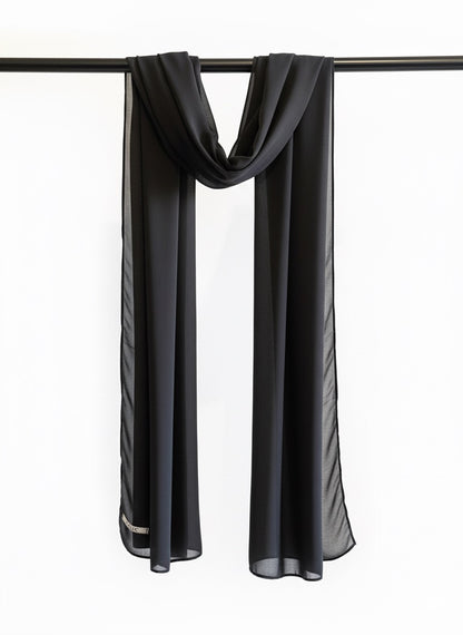 Black scarf draped over a black rod on a white background