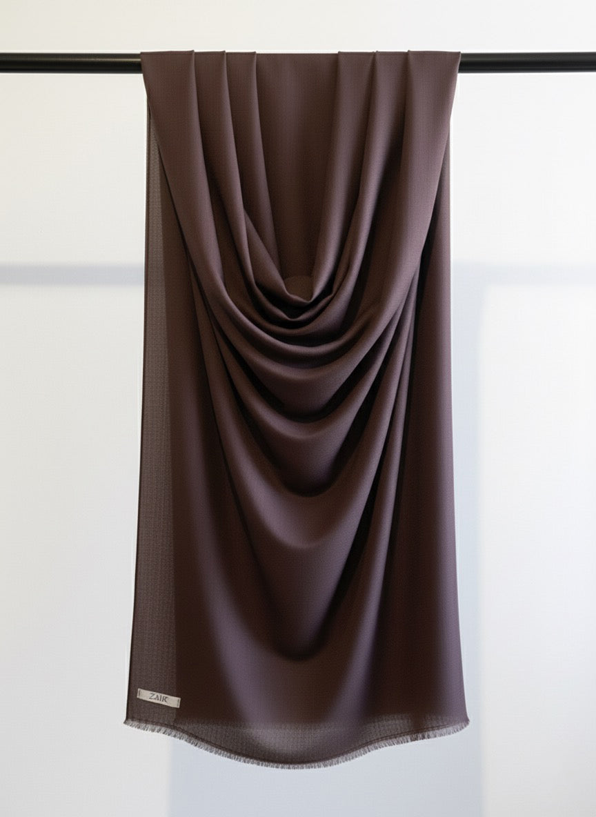 Dark Brown scarf draped over a black rod against a white background