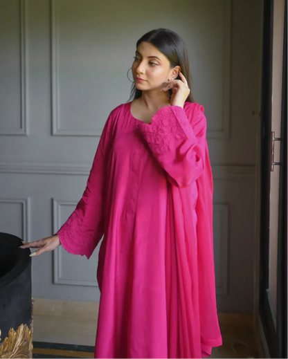 Women wearing a three piece pink color dress with embroidery on sleeves.