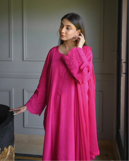 Women wearing a three piece pink color dress with embroidery on sleeves.