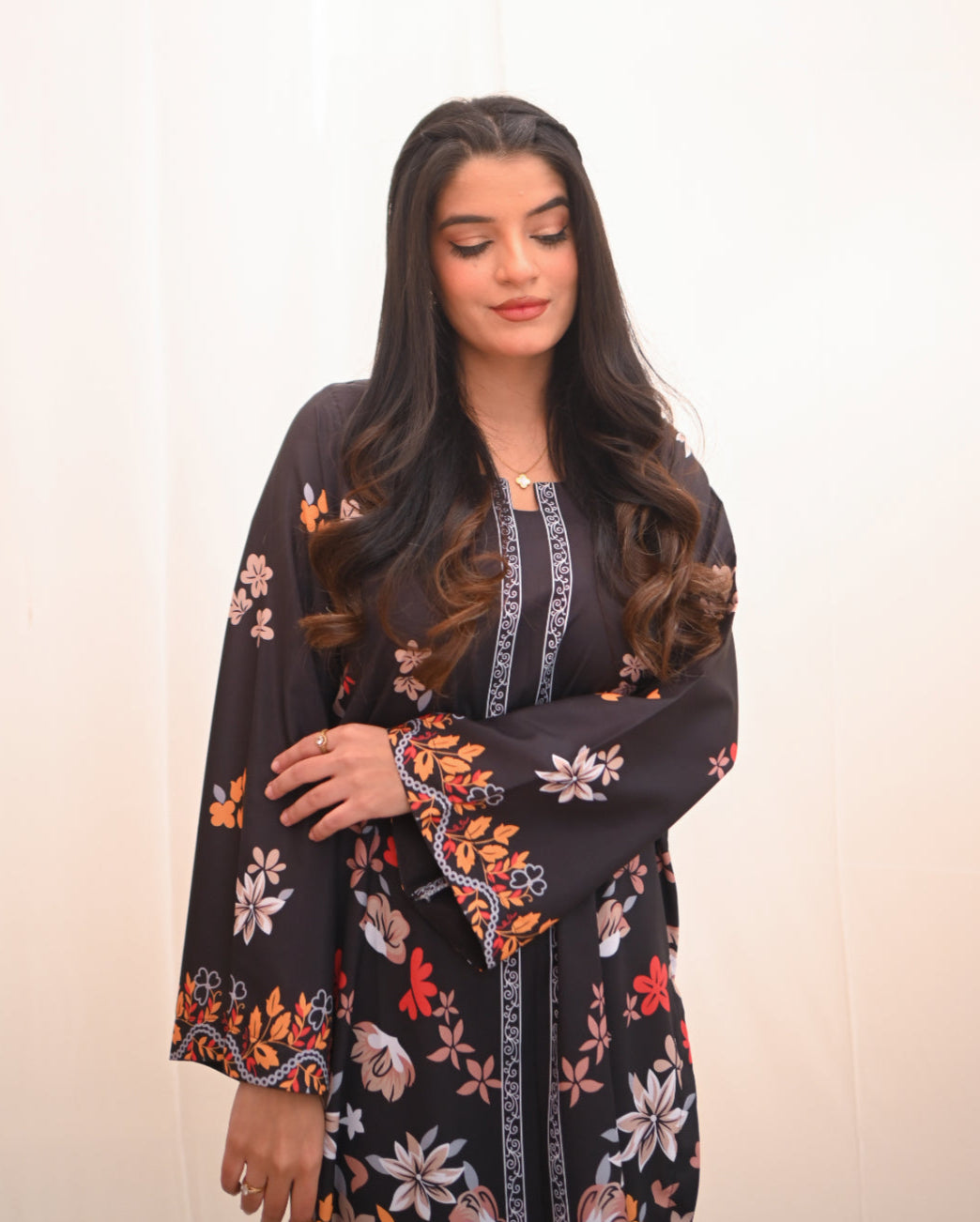 Women wearing a printed black two piece dress.