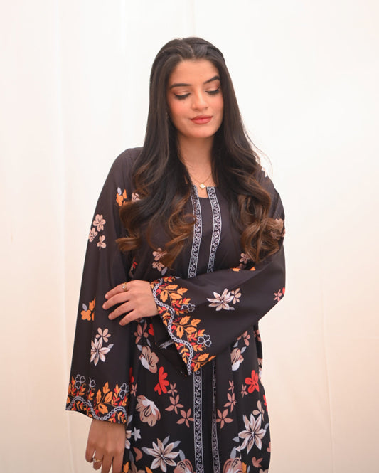 Women wearing a printed black two piece dress.