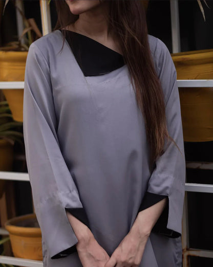 Close up on the women wearing a gray dress.