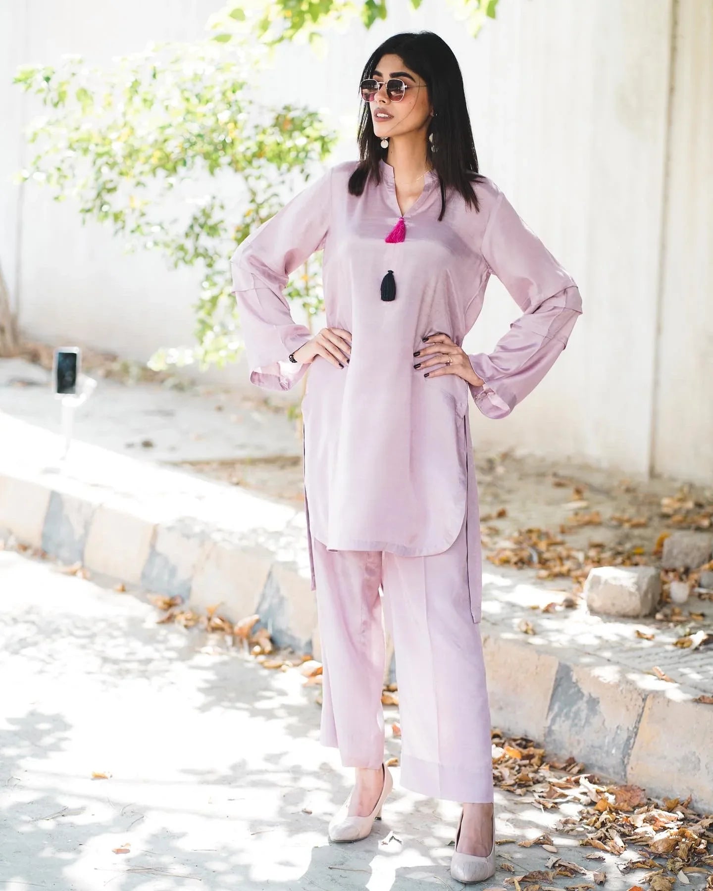 Women wearing a lilac two-piece cotton silk suit with a V-neckline shirt and culotte.