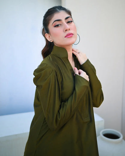Woman wearing a green dress with a blurred background