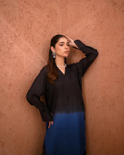 A woman wearing a Rawsilk Ombre shirt  standing in a room with earthen tones.