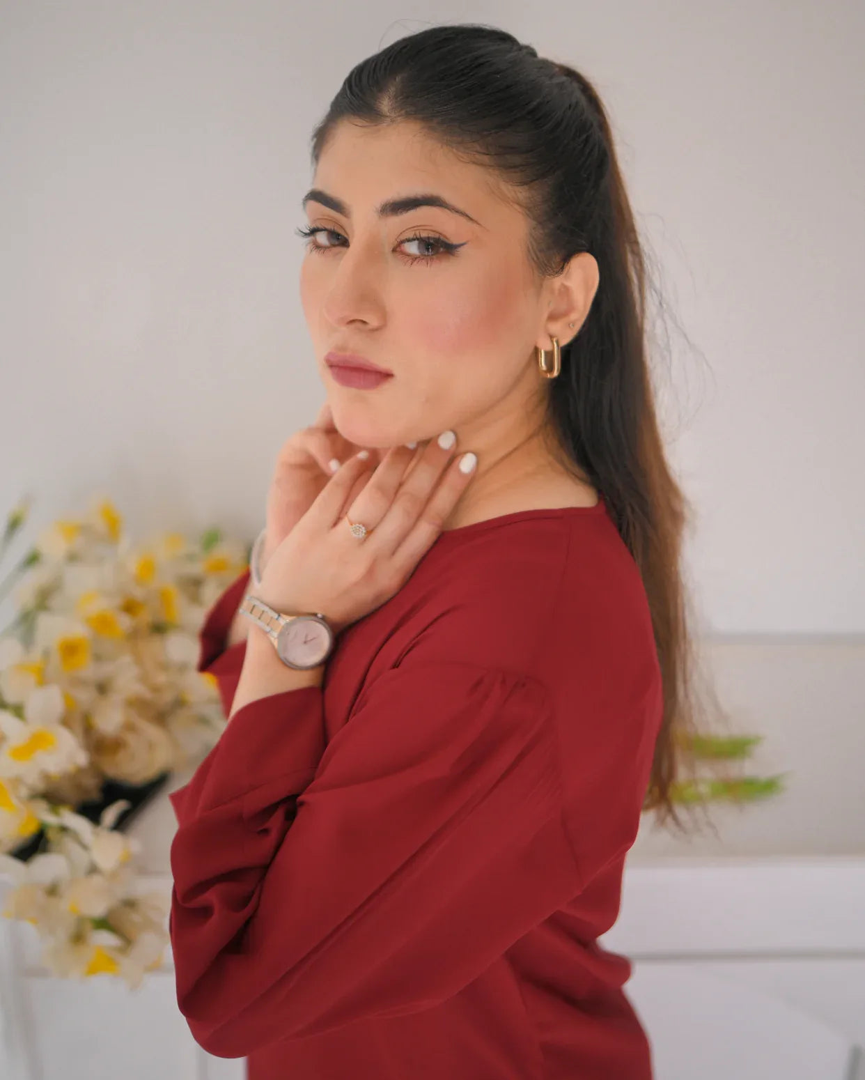 Close p of a women wearing a red top with full sleeves.