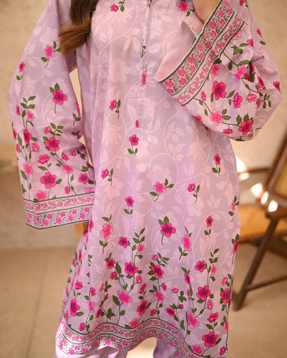 Close up of a women wearing floral printed pink dress.