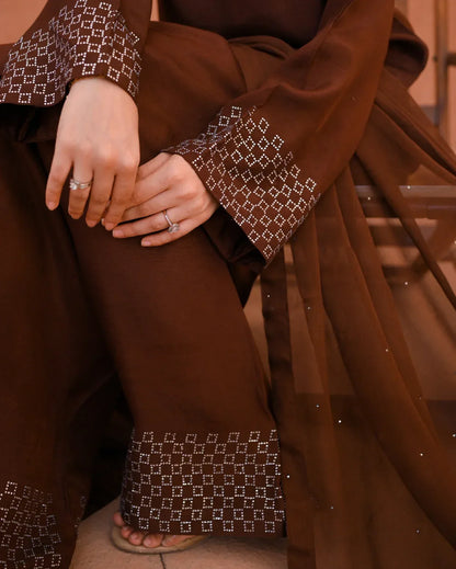 close up of a rawsilk dress and chiffon dupatta. Stone work on dress and dupata.