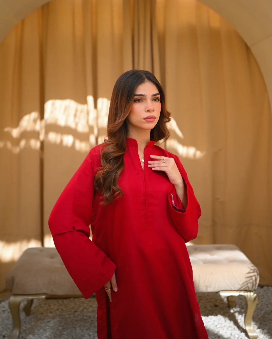 A Women wearing a Solid Red color two piece dress which includes a shirt and a culotte.