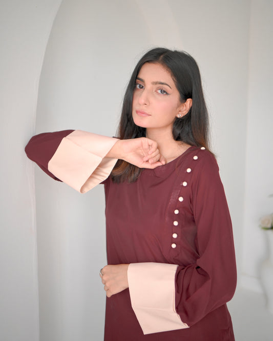 Women wearing a maroon dress with phone color borders on sleeves.