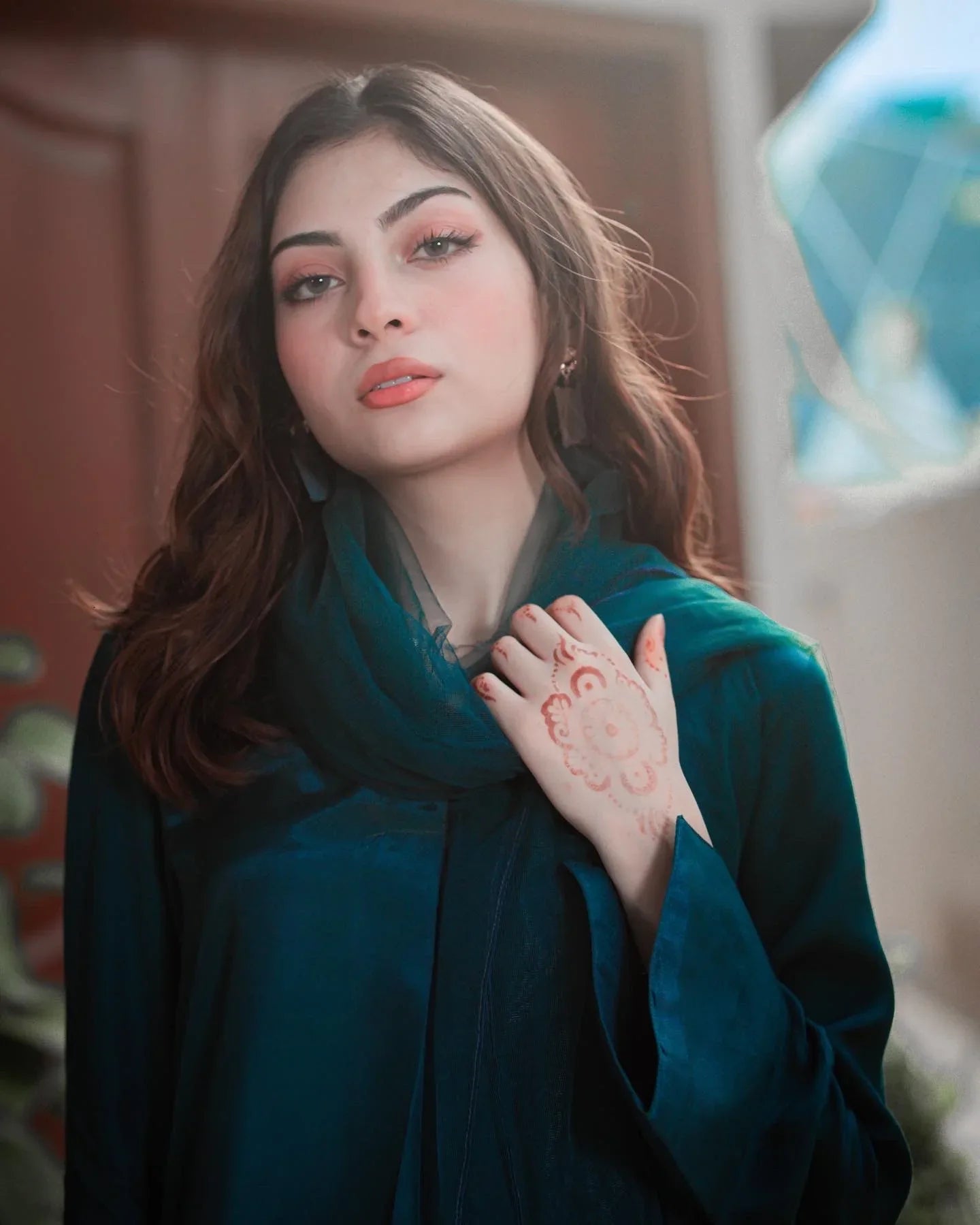 Close up of the women wearing a teal blue dress.