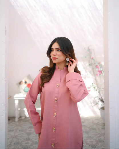 A woman wearing a pink indian rawsilk fabric shirt.