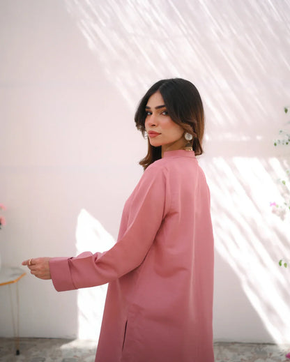 A woman wearing a pink indian rawsilk fabric shirt.