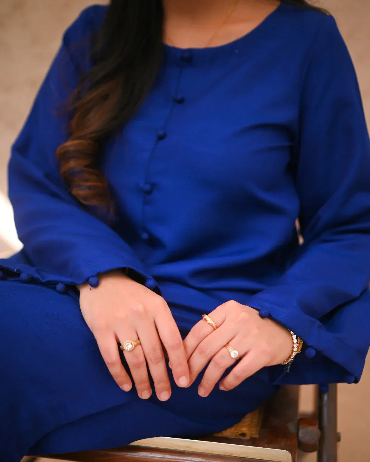 Close up of a women wearing a blue dress.