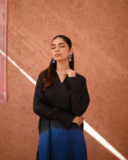 A woman wearing a Rawsilk Ombre shirt standing in a room with earthen tones.